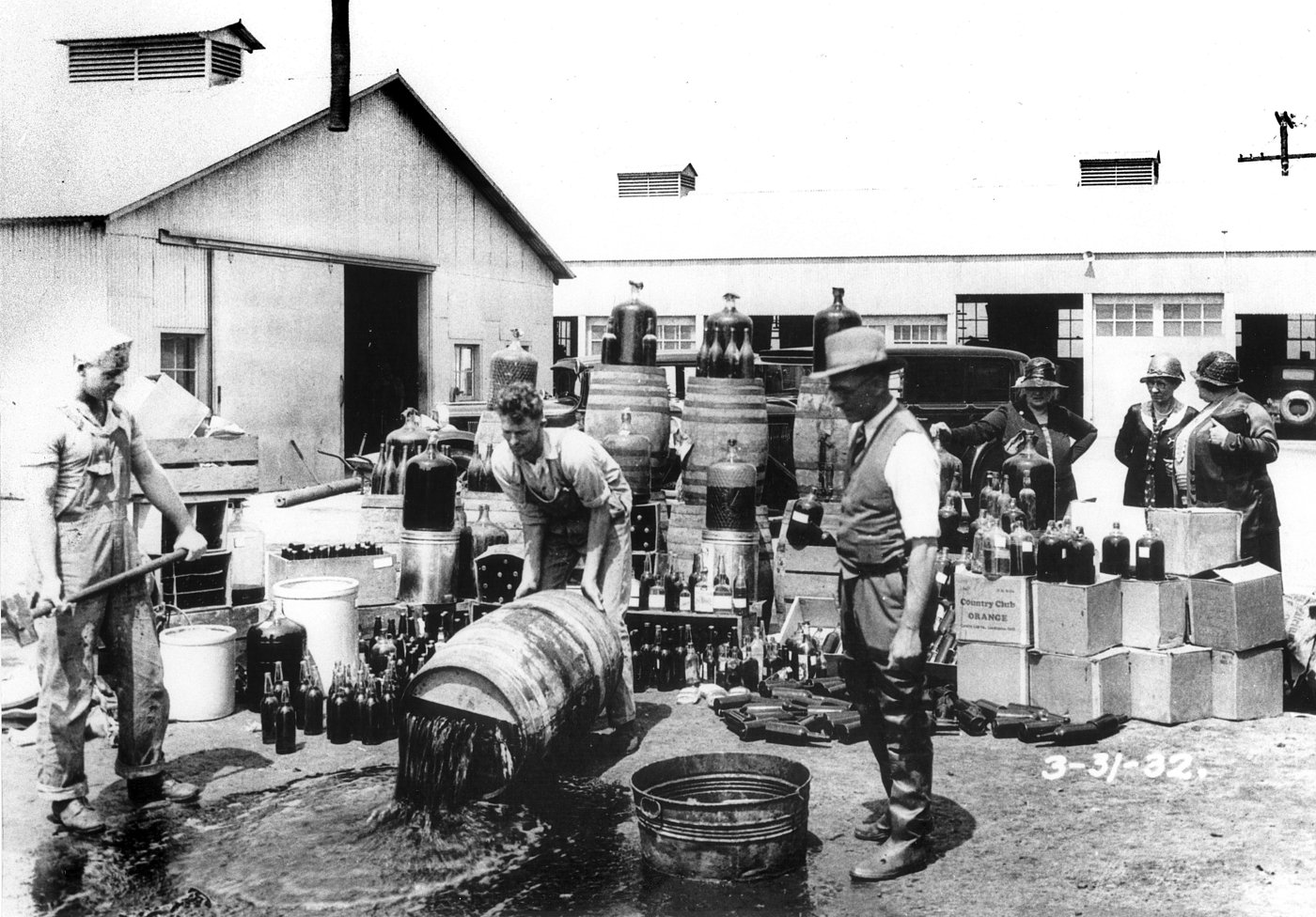 Sheriff's deputies dumping illegal alcohol in California, 1932